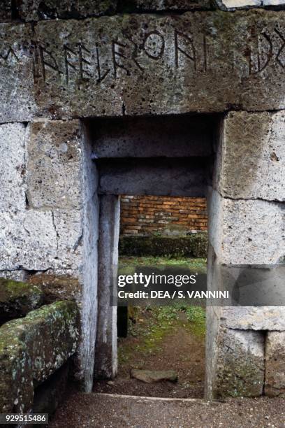 Inscription on the architrave above the entrance to a tomb, Etruscan necropolis of the Crocifisso del Tufo, Orvieto, Umbria, Italy. Etruscan...