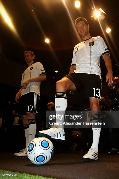 Michael Ballack poses with a ball after the presentation of the new German FIFA World Cup 2010 jersey 'Teamgeist' at the adidas Brand Center on...