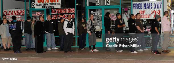 People line up to buy copies of the highly anticipated video game "Call of Duty: Modern Warfare 2" at a GameStop Corp. Store early November 10, 2009...