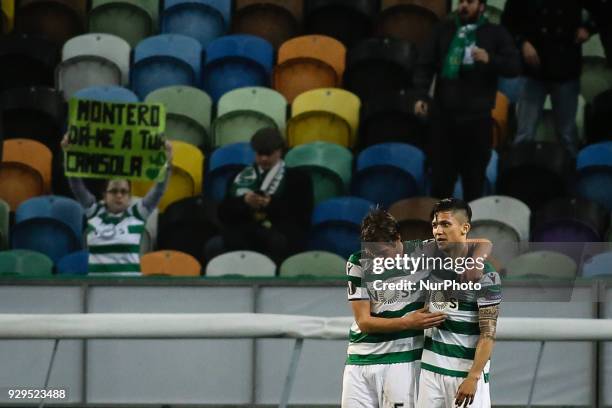 Sporting's Colombian forward Fredy Montero celebrates a goal with Sporting's defender Fabio Coentrao during the UEFA Europa League round of 16 match...