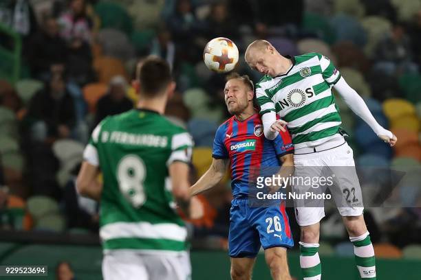 Sporting's defender Jeremy Mathieu from France heads the ball with Plzen's midfielder Daniel Kolar of Czech Republic during the UEFA Europa League...