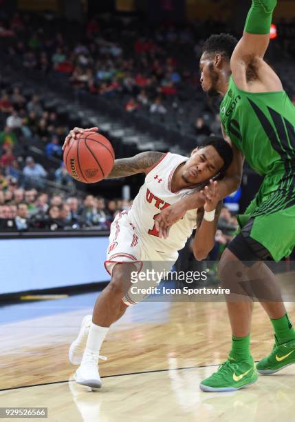 Utah guard Justin Bibbins smashes his head into the gut of Oregon forward Troy Brown during the PAC-12 Men's Basketball Tournament game between the...