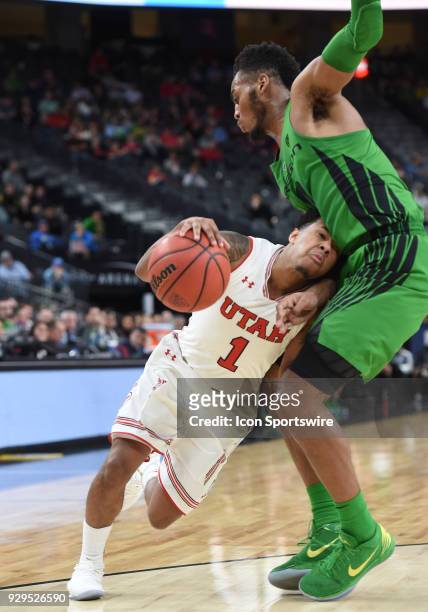 Utah guard Justin Bibbins smashes his head into the gut of Oregon forward Troy Brown during the PAC-12 Men's Basketball Tournament game between the...