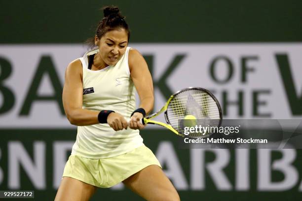 Zarina Diyas of Kazakhstan returns a shot to Serena Williams during the BNP Paribas Open at the Indian Wells Tennis Garden on March 8, 2018 in Indian...