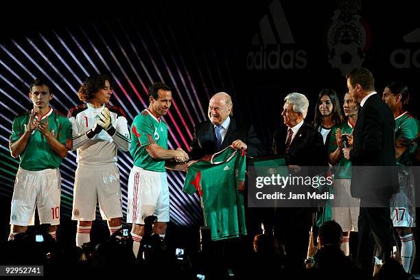President Joseph Blatter shake hands with Mexican soccer player Gerardo Torrado and Justino Compean president of Mexican Federation during the...