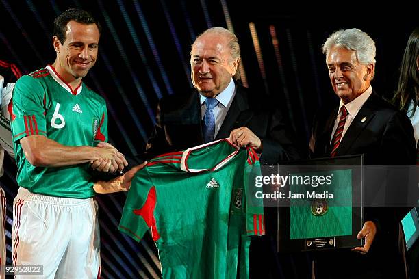 President Joseph Blatter shake hands with Mexican soccer player Gerardo Torrado and Justino Compean president of Mexican Federation during the...