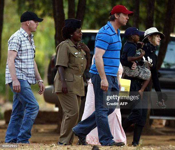 American pop queen Madonna carries her adopted son David Banda during a visit to the "Home of Hope" Children's Home in Mchinji, 120 kms west of...