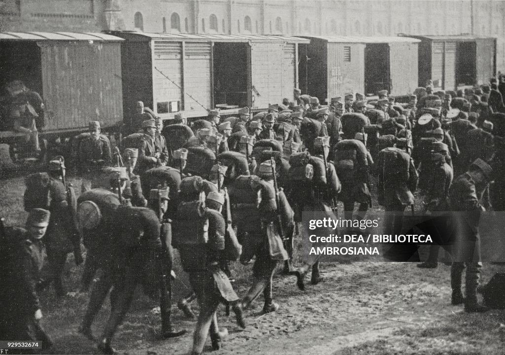 Troops and materials embarking onto trains