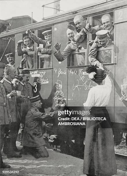 Caricaturists improvising drawings on a reservists train before its departure from Berlin, Germany, World War I, photograph by Berliner Ill Gesel,...