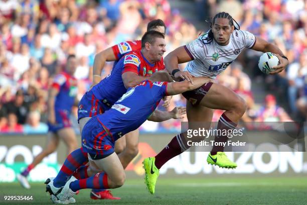 Martin Taupau of the Sea Eagles is tackled during the round one NRL match between the Newcastle Knights and the Manly Sea Eagles at McDonald Jones...