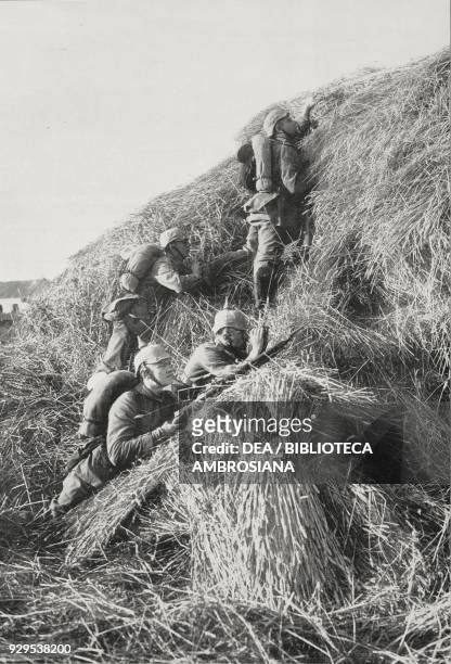 German outposts behind a pile of straw near Ypres observing enemy movements, Flanders, Belgium, World War I, photograph by R Semecke, from...