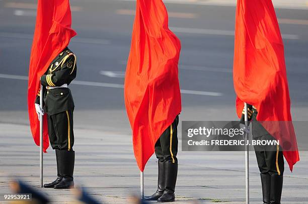 Chinese paramilitary honour guards stand by red flags at a welcoming ceremony for visiting President of Brazil, Luiz Inacio Lula da Silva who met...
