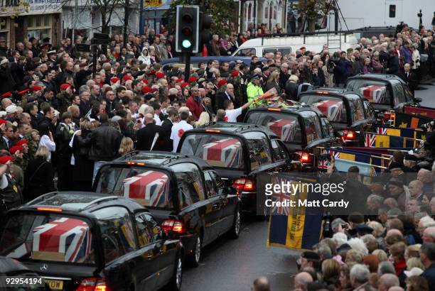 Friends and family pay their respects, as the hearses carrying the coffins of six dead soldiers pass mourners lining the High Street on November 10,...