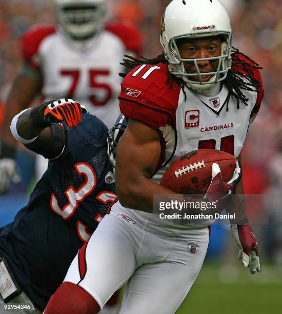 Larry Fitzgerald of the Arizona Cardinals shakes off a tackle attempt by Charles Tillman of the Chicago Bears to score a touchdown at Soldier Field...
