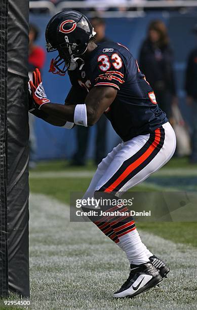 Charles Tillman of the Chicago Bears practices his hand work by hitting the goal post during warm-ups before a game against the Arizona Cardinals at...