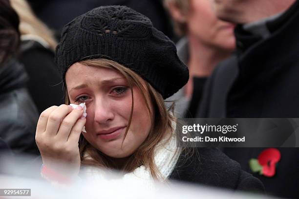 Friends and family react as the hearses carrying the coffins of six dead soldiers pass mourners lining the High Street on November 10, 2009 in...