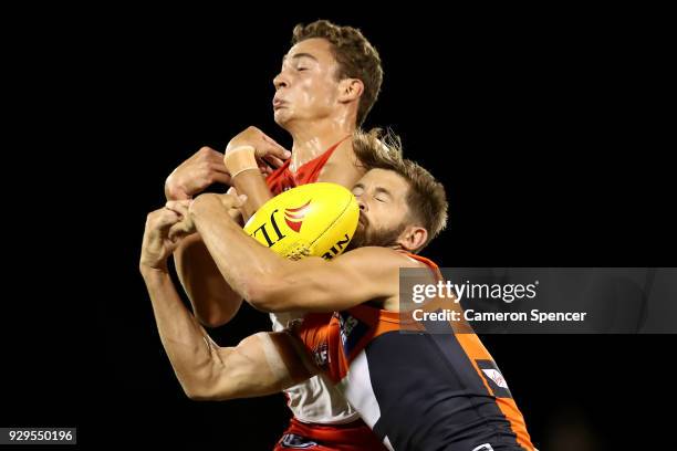 Callan Ward of the Giants and Will Hayward of the Swans contest the ball during the JLT Community Series AFL match between the Sydney Swans and the...