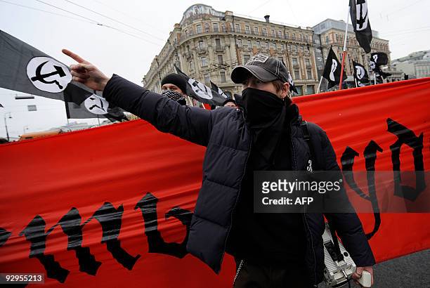 Russian Communist party supporters march in Moscow on November 7 marking the 92th anniversary of Vladimir Lenin's overthrow of the Tsarist empire, an...