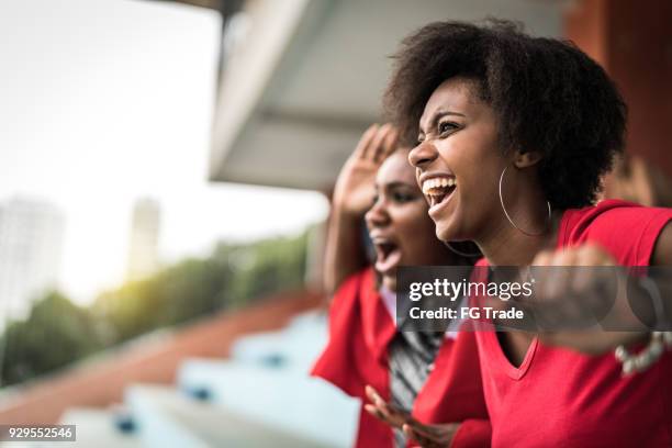 afro friends watching a soccer game - female fans brazil stock pictures, royalty-free photos & images