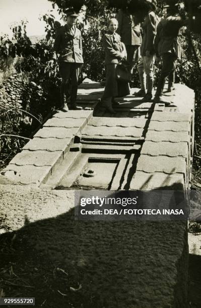 Archaeologist Ugo Monneret de Villard and Italian officials standing on a stele, Axum, Ethiopia, 1935-1936.