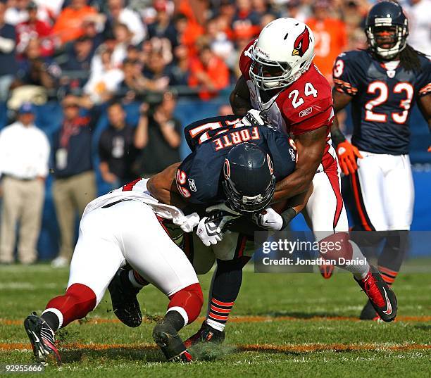 Matt Forte of the Chicago Bears is tackled by Chike Okeafor and Adrian Wilson of the Arizona Cardinals at Soldier Field on November 8, 2009 in...