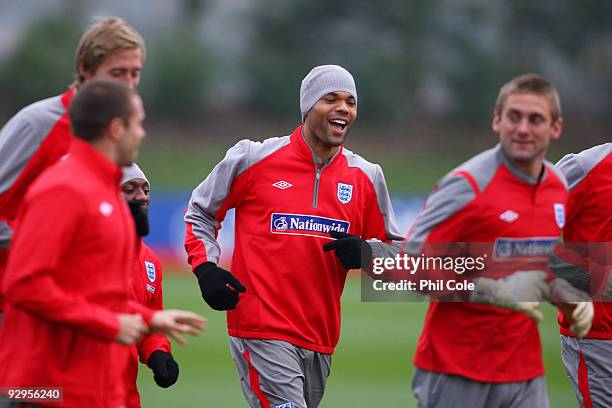 Joleon Lescott of England warms up with team mates during a training session at London Colney on November 10, 2009 in St Albans, England.