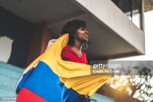 colombian fan watching a soccer game - columbian stock pictures, royalty-free photos & images