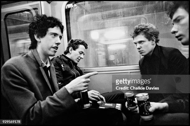British punk group The Clash in conversation with NME journalist Tony Parsons, on the London Underground Circle Line in April 1977. Left to right...