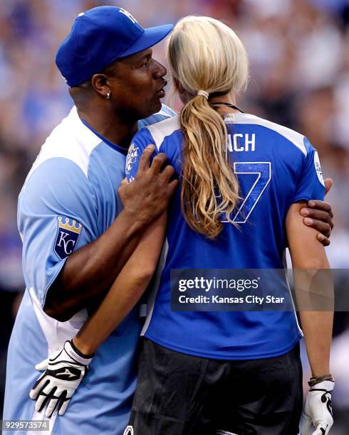 Former NFL and baseball star Bo Jackson whispers into the ear of Jennie Finch, former United States National Softball team pitcher, during the...