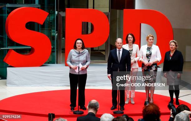 Social Democrats party leaders Andrea Nahles and Olaf Scholz stand next to designated German Justice Minister Katarina Barley, designated German...