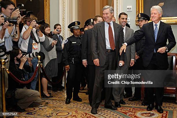 Former U.S. President Bill Clinton is accompanied by Sen. Sheldon Whitehouse as he heads into the Senate Democratic Caucus luncheon at the U.S....