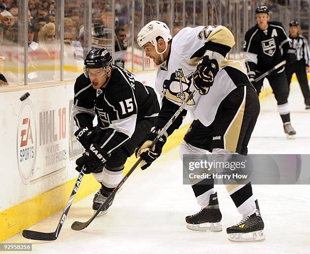 Craig Adams of the Pittsburgh Penguins and Brad Richardson of the Los Angeles Kings go after a puck along the boards during the game at the Staples...