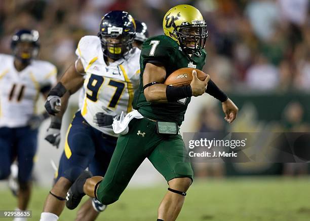 Quarterback B.J. Daniels of the South Florida Bulls scrambles against the West Virginia Mountaineers during the game at Raymond James Stadium on...