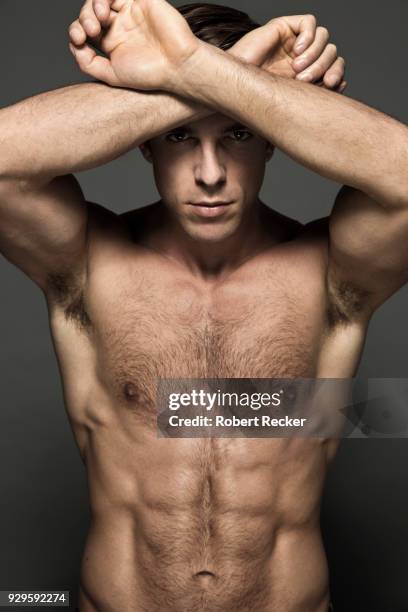 topless man crossing arms in front of forehead - brusthaar stock-fotos und bilder