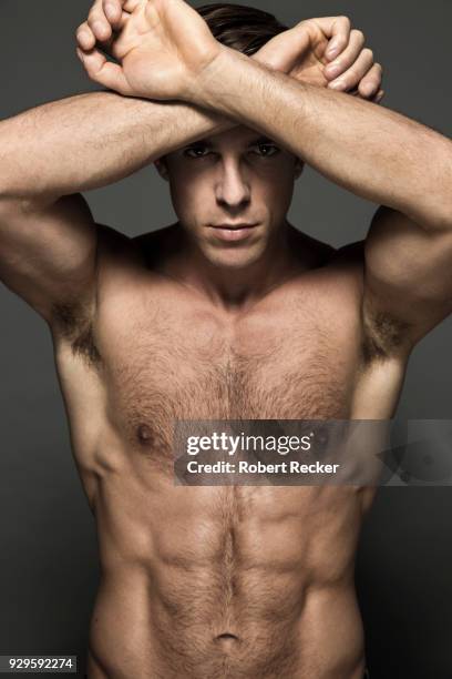 topless man crossing arms in front of forehead - chest hair stock pictures, royalty-free photos & images