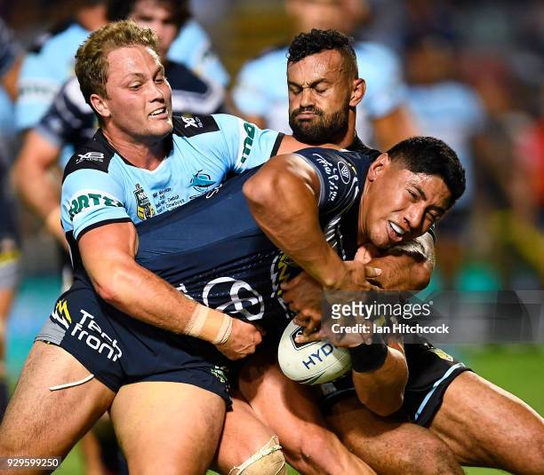 Jason Taumalolo of the Cowboys is tackled by Matt Moylan of the Sharks during the round one NRL match between the North Queensland Cowboys and the...