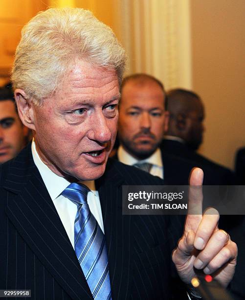 Former US President Bill Clinton talks with reporters after discussing health care legislation during the Democrats' weekly caucus on November 10,...