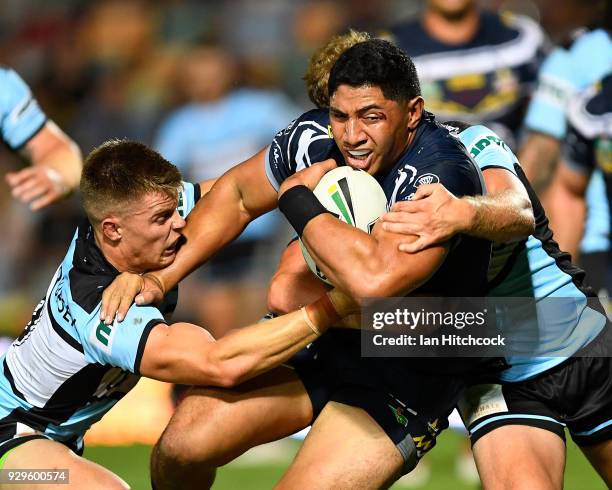 Jason Taumalolo of the Cowboys is tackled by Matt Moylan and Jayden Brailey of the Sharks during the round one NRL match between the North Queensland...