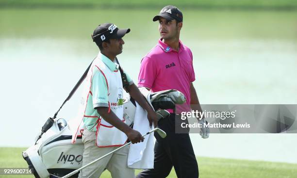 Shubhankar Sharma of India looks on with his caddie during day two of the Hero Indian Open at Dlf Golf and Country Club on March 9, 2018 in New...