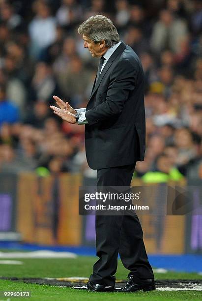 Coach Manuel Pellegrini of Real Madrid calms his players during the Copa del Rey fourth round, second leg match between Real Madrid and AD Alcorcon...