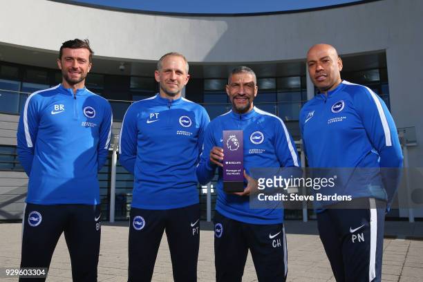 Chris Hughton, the Manager of Brighton and Hove Albion and his coaching staff pose with the Barclays Manager of the Month Award for February 2018 at...