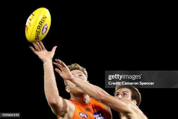 Dawson Simpson of the Giants taps the ball during the JLT Community Series AFL match between the Sydney Swans and the Greater Western Sydney Giants...