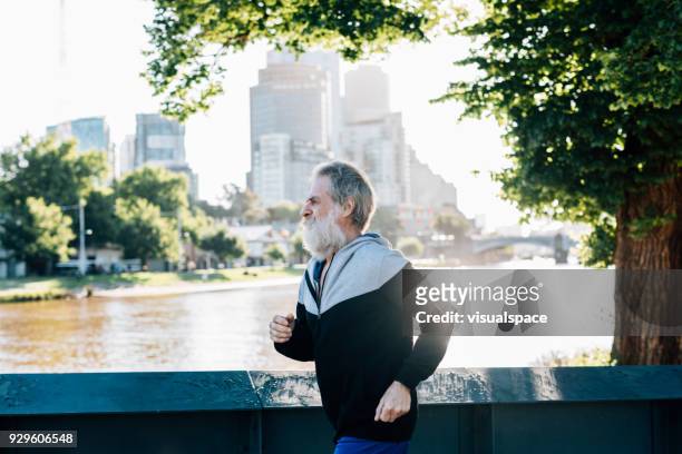 active senior and melbourne cityscape - melbourne city training session stock pictures, royalty-free photos & images