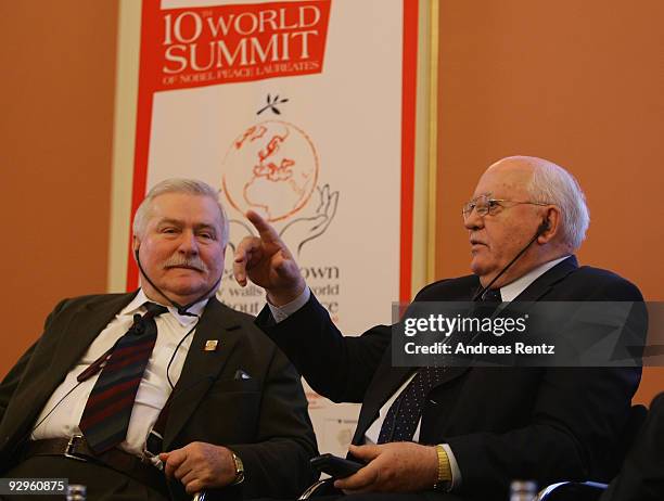 Former Polish president Lech Walesa and former Soviet President Mikhail Gorbachev gesture during their speech at the 10th World Summit of Nobel Peace...