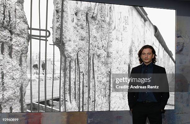 Manuele Malenotti, Vice president of Belstaff, poses in front of a video display that shows images from the former Berlin wall at the 10th World...