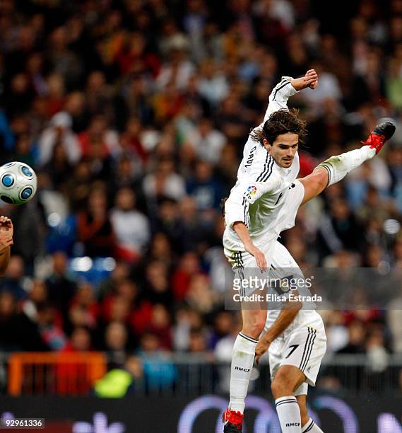 Fernando Gago of Real Madrid jumps for a high ball during the Copa del Rey match between Real Madrid and AD Alcorcon at Estadio Santiago Bernabeu on...