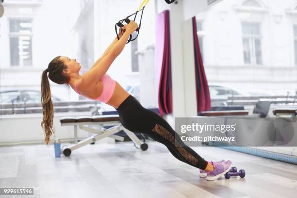 girl exercising in the gym - suspension training stock pictures, royalty-free photos & images