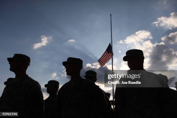 Army soldiers stand together as they prepare to leave after the memorial service that U.S. President Barack Obama and first lady Michelle Obama...