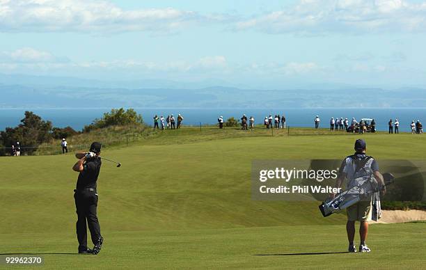 Hunter Mahan of the USA plays an approach shot on the 4th hole during the first round of The Kiwi Challenge at Cape Kidnappers on November 11, 2009...