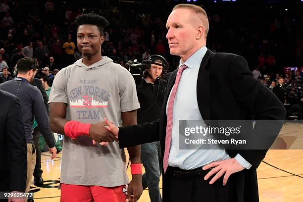 Kassoum Yakwe and head coach Chris Mullin of the St. John's Red Storm react after a victory over the Georgetown Hoyas during the first round of the...